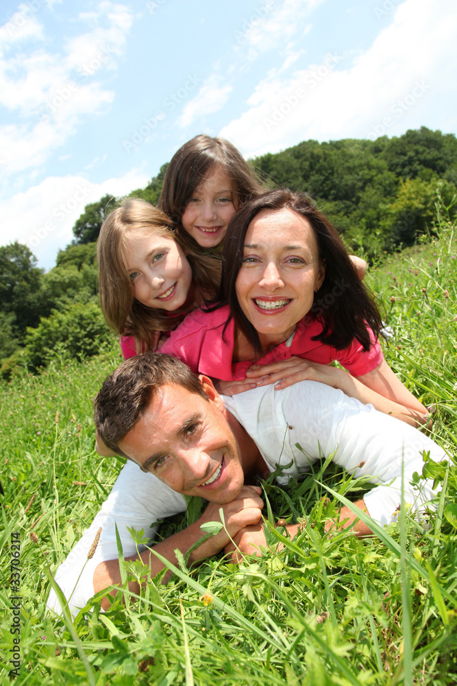 Fototapeta premium Happy family laying down in park