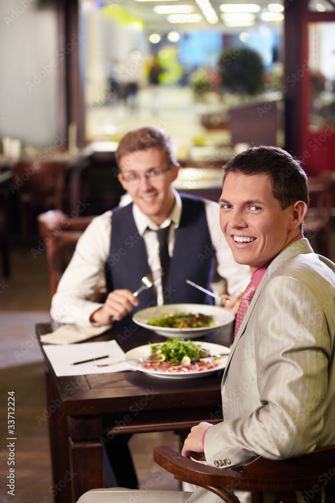 Two men having lunch in a restaurant Two men having lunch in a restaurant