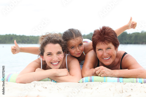 grandmother, mother and daughter on the beach