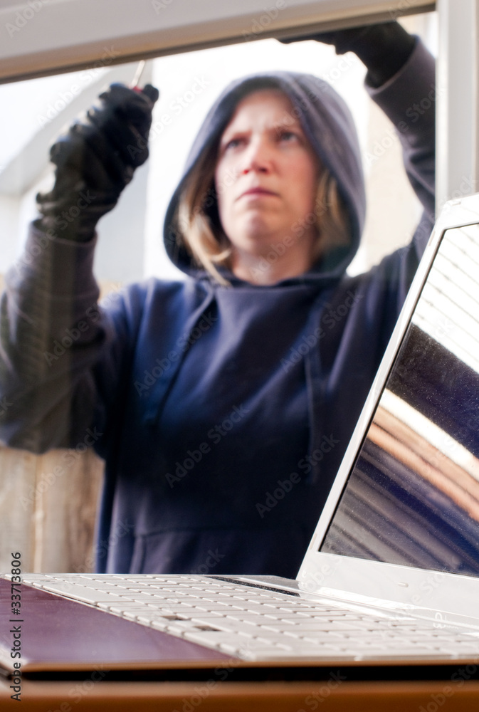 Burglar breaking into house for laptop Burglar breaking into house for laptop