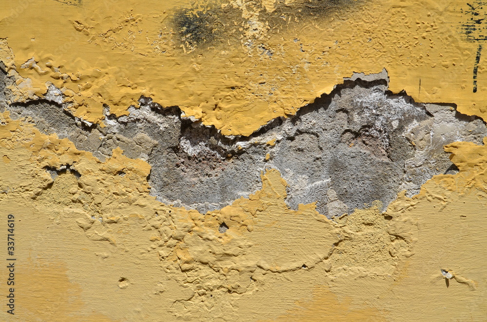 flaking, peeling yellow wallplaster