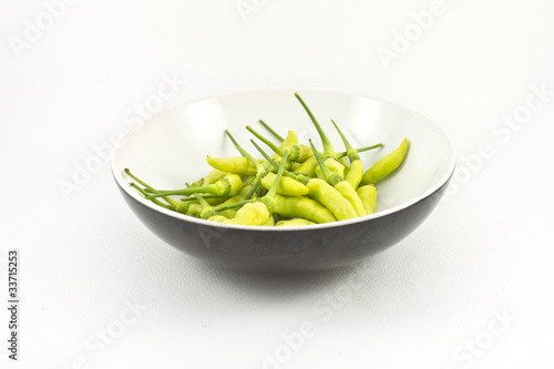 chili peppers in cup on white background