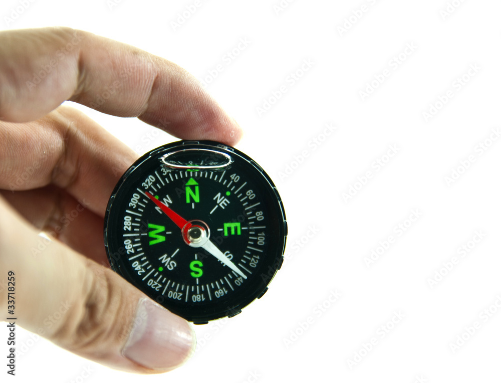 Hand holding a compass isolated on white background Hand holding a compass isolated on white background