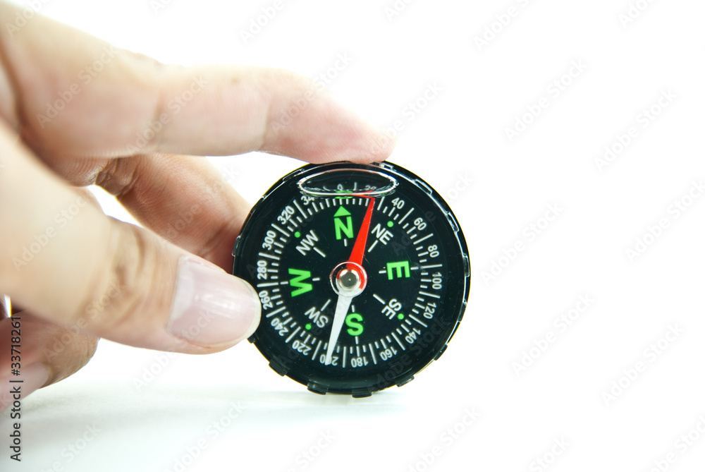 Hand holding a compass isolated on white background Hand holding a compass isolated on white background