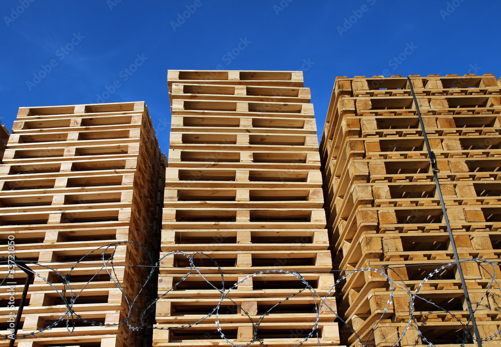 many wooden pallets placed in warehouse coutyard