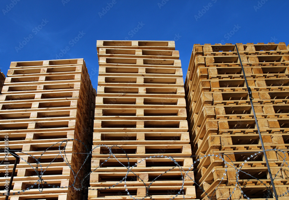 many wooden pallets placed in warehouse coutyard many wooden pallets placed in warehouse coutyard