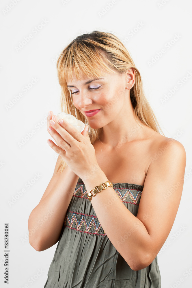Beautiful young woman holding a white flower at face Beautiful young woman holding a white flower at face