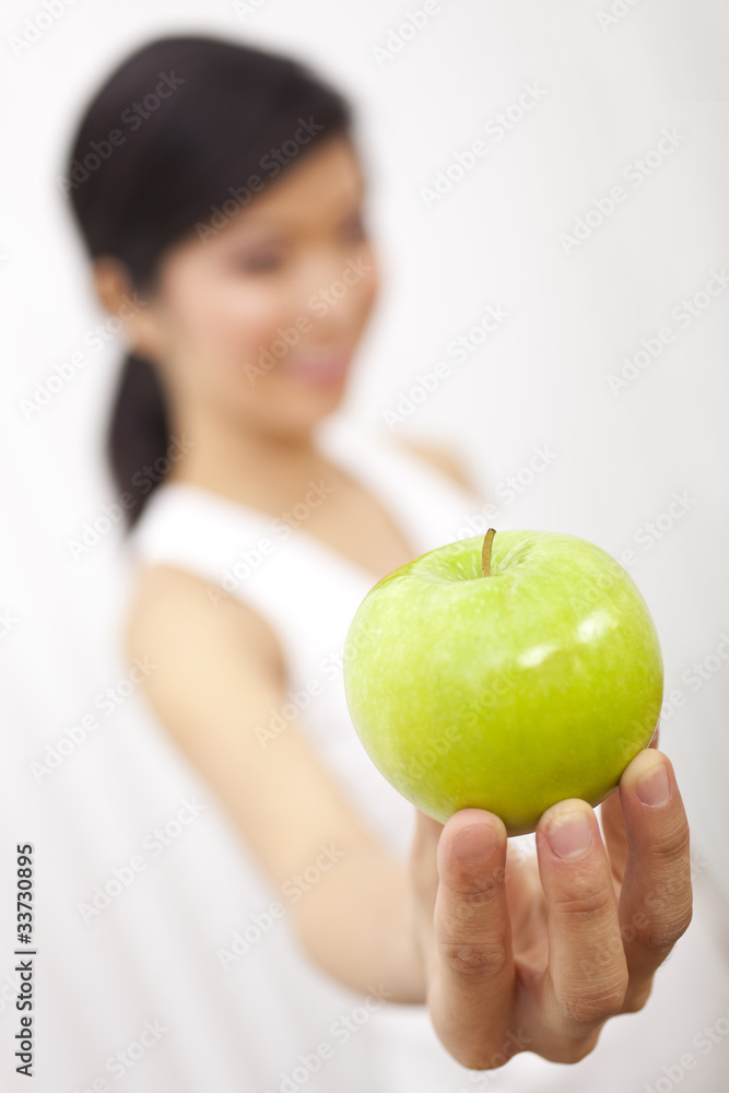 Asian Chinese Girl Holding Fresh Green Apple to Camera Asian Chinese Girl Holding Fresh Green Apple to Camera
