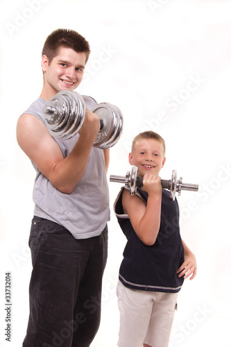 man and son exercise at gym