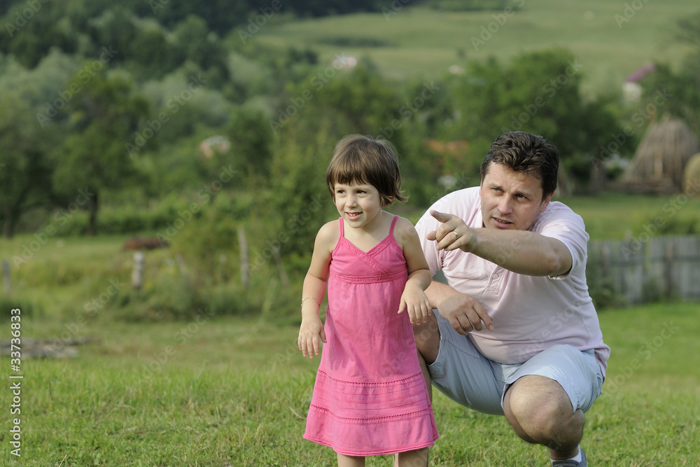 Fototapeta premium happy little girl studying nature with her father