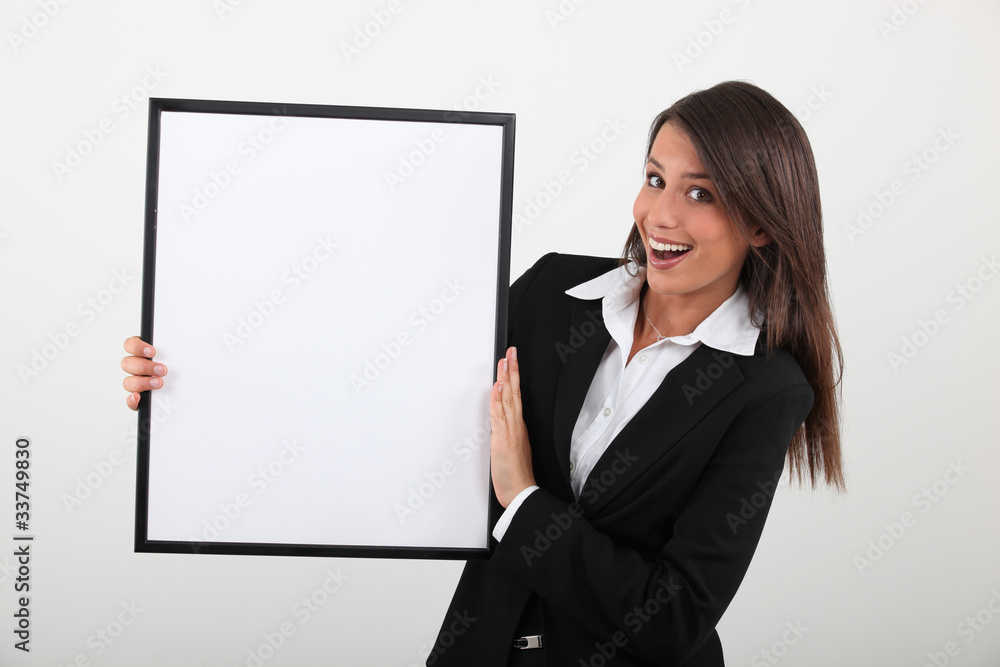Delighted woman holding a black framed board left blank Delighted woman holding a black framed board left blank