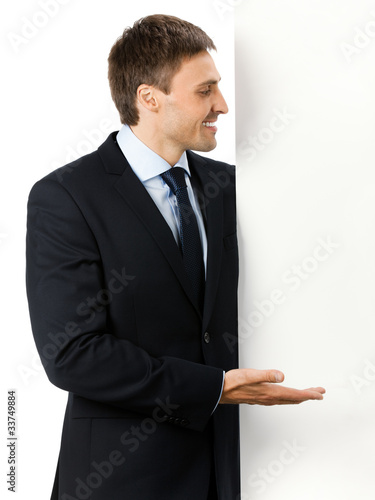 Happy business man showing blank signboard, isolated