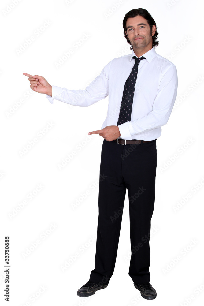 man in a suit pointing at something man in a suit pointing at something