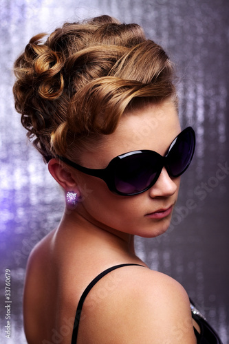 Young woman wearing sunglasses.