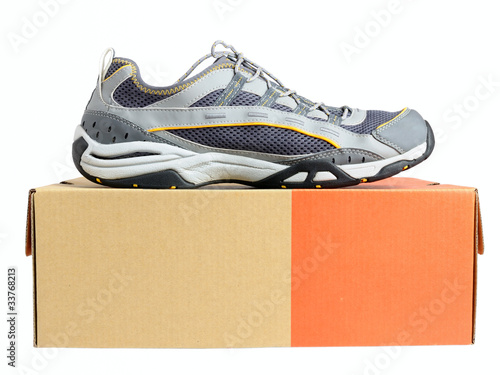 Sneakers on shoe cardboard box isolated on white background