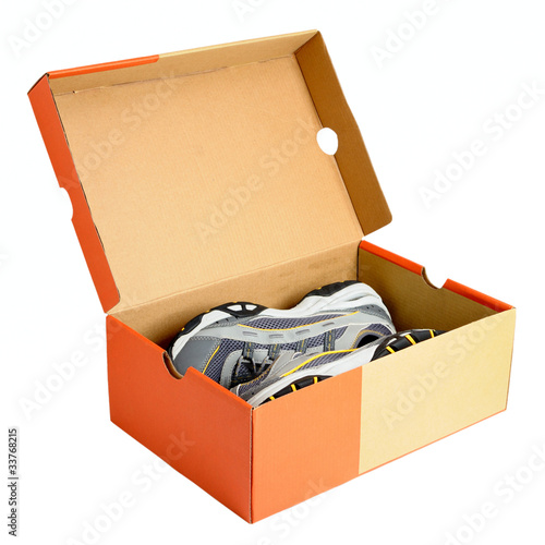 Pair of sneakers in shoe cardboard box