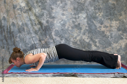 woman doing Yoga posture Chaturanga Dandasana or Four-Limbed Sta