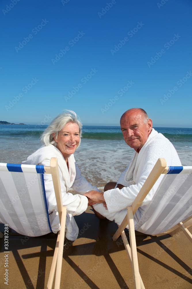 Portrait of senior couple sitting in deckchairs