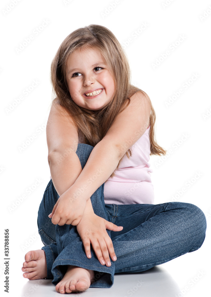 Cute happy little girl sitting on white background