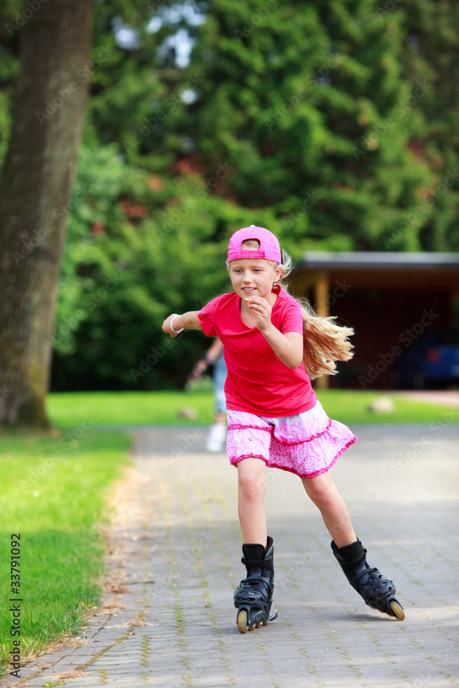 Fototapeta premium young girl outdoors inline skating fun