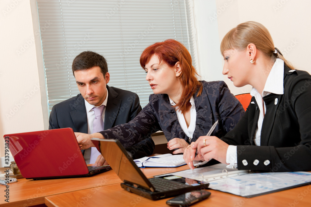 Three business people are meeting Three business people are meeting