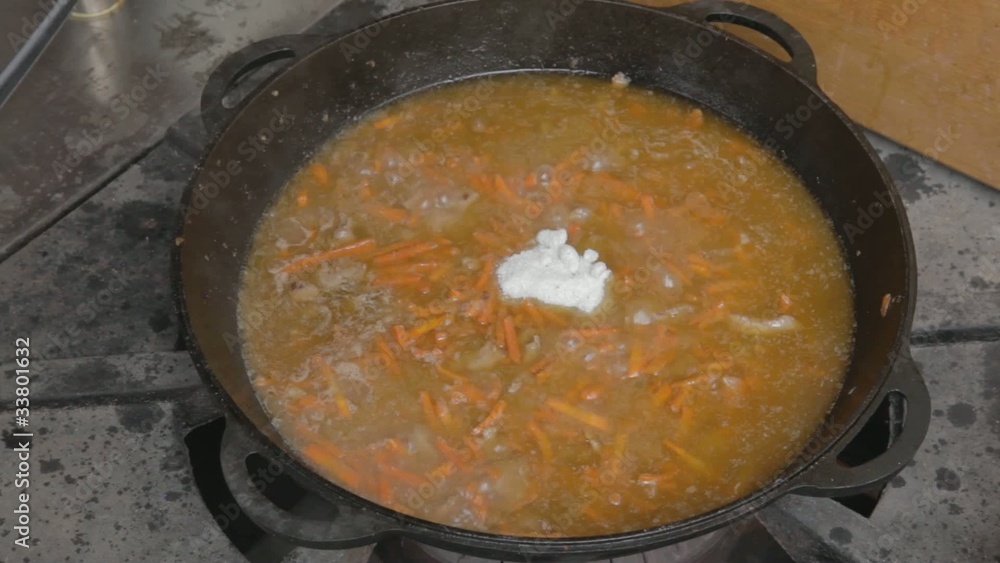 EDIT Adding salt to stewing pork slices and chopped carrot EDIT Adding salt to stewing pork slices and chopped carrot