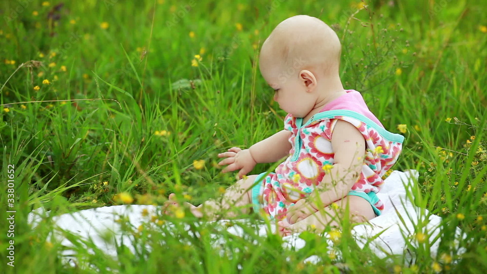Newborn baby sitting in the meadow Newborn baby sitting in the meadow