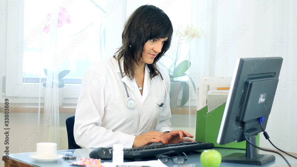 Portrait of female doctor working on computer Portrait of female doctor working on computer