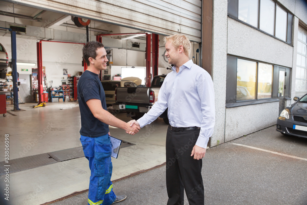 Mechanic shaking hands with client