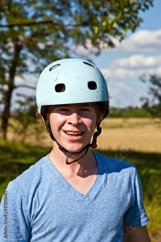 portrait of cute boy with helmet in the nature © travelview