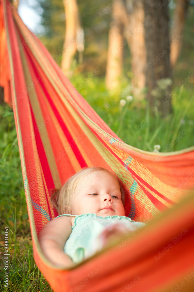 Adorable baby girl relaxing in hammock Adorable baby girl relaxing in hammock