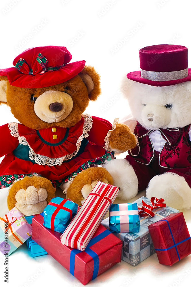 Two teddy bears share Christmas presents morning.