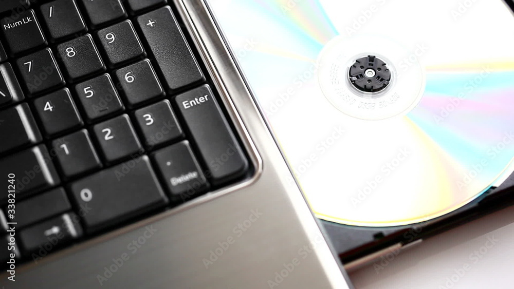 Male hand inserting/ejecting a disc from a laptop Male hand inserting/ejecting a disc from a laptop