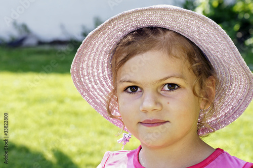 Smiling little girl with straw sunhat