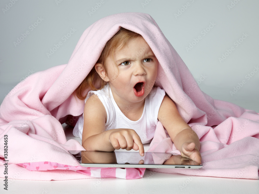 Portrait of shouting little girl playing with touchpad Portrait of shouting little girl playing with touchpad