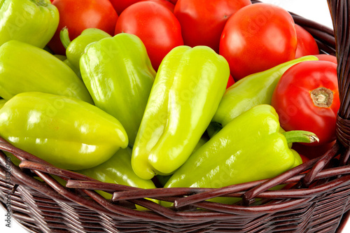 Big green peppers and red tomatoes in basket
