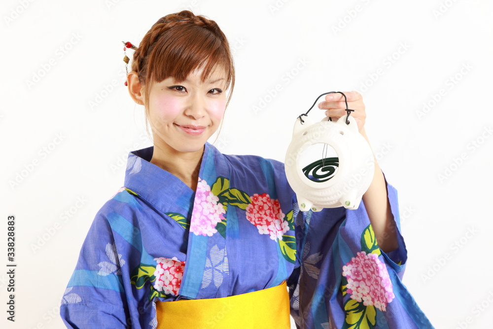 Young woman wearing Japanese kimono with mosquito coil Young woman wearing Japanese kimono with mosquito coil
