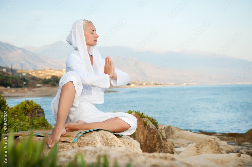 Young woman meditating outdoors