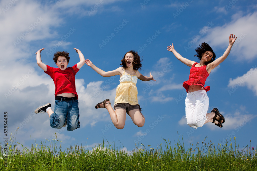 Active family - mother and kids jumping outdoor Active family - mother and kids jumping outdoor