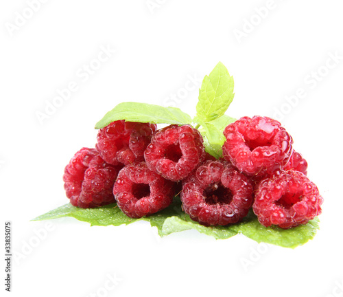 Raspberries stack decorated witn mint leaves on white