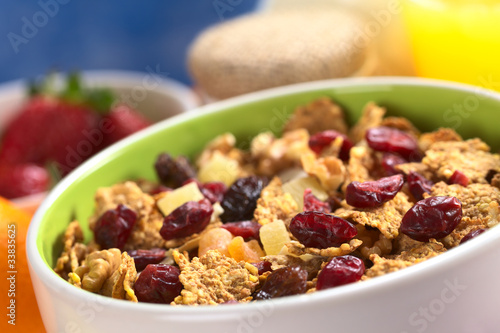 Bowl full of wholewheat flakes mixed with dried fruits