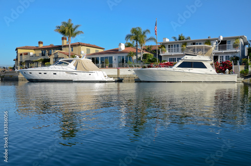 A boat in Newport Beach, California outside of a home.
