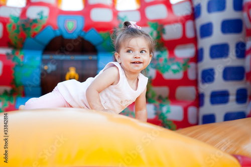 Happy child jumping on trampoline outdoors