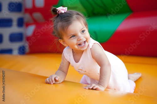 Happy child jumping on trampoline outdoors