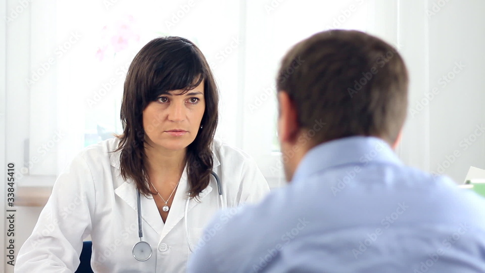 Female doctor telling bad news to male patient Female doctor telling bad news to male patient