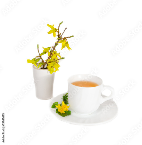 Fototapeta Naklejka Na Ścianę i Meble -  A cup of black tea and flowers in vase