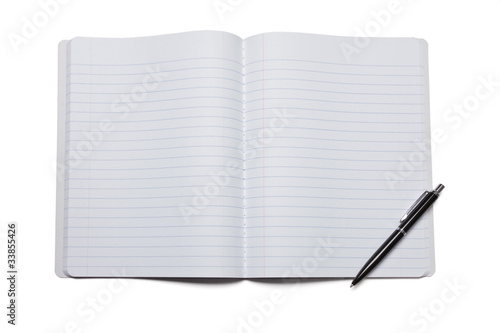 Pen and opened composition notebook with copy space