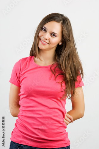 Portrait of a beautiful young woman looking happy against