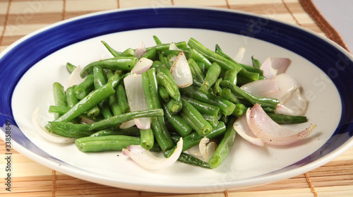 Friend French bean with onion on plate