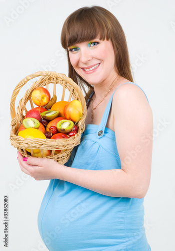 A pregnant woman with fruit